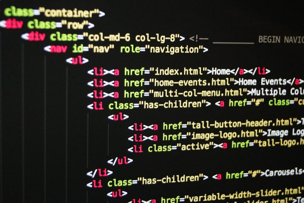 Close-up of vibrant HTML code displayed on a computer screen, showcasing web development and programming.